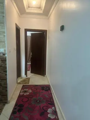 a hallway with a red rug on the floor at H&H Twin Apartment in Hurghada