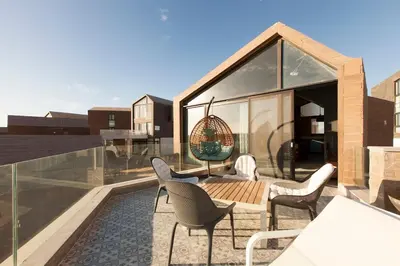 a patio with chairs and a table on a roof at Stylish Seaview 2BR Soma bay Villa with Free Pool & Beach in Hurghada