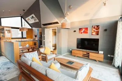a living room with a couch and a television at Stylish Seaview 2BR Soma bay Villa with Free Pool & Beach in Hurghada