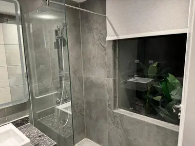 a bathroom with a glass shower and a sink at 2 BR with a small private pool in Hurghada