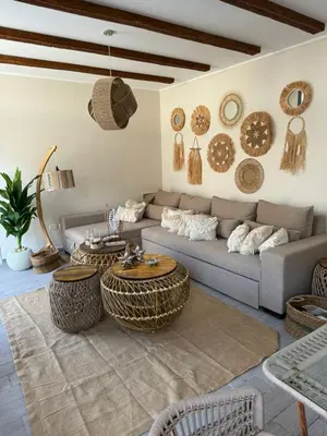 a living room with a couch and tables and baskets on the wall at 2 BR with a small private pool in Hurghada