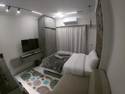 a small bedroom with a bed and a tv at Dive Hostel Hurghada Beach in Hurghada