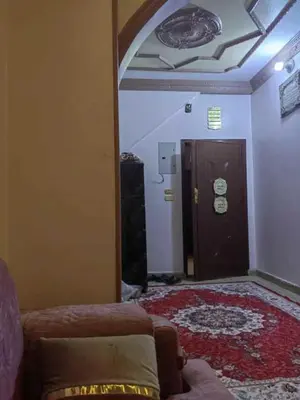 a living room with a door and a couch in a room at شقة فاخرة خلف الاستاد اسوان in Aswan