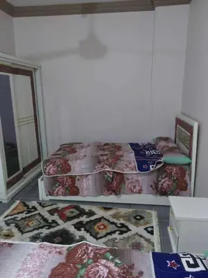 a bedroom with two twin beds and a window at شقة فاخرة خلف الاستاد اسوان in Aswan
