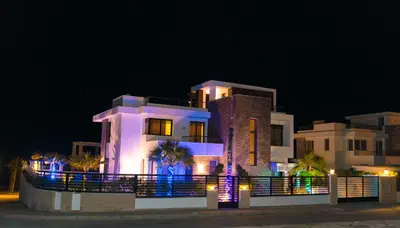 a large house with lights in front of it at night at Palmen Villa in Hurghada
