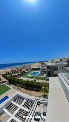a view of the beach from the balcony of a building at Palmen Villa in Hurghada