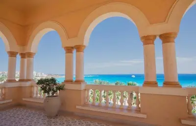 a balcony with a view of the ocean at Palmen Villa in Hurghada