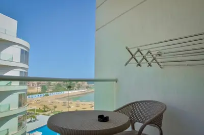a table and chairs on a balcony with a view at Angeli Apartment Scandic Rezort in Hurghada