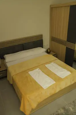 a bedroom with a large bed with two towels on it at Angeli Apartment Scandic Rezort in Hurghada