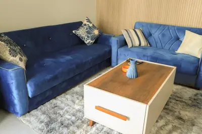 a living room with a blue couch and a coffee table at Angeli Apartment Scandic Rezort in Hurghada