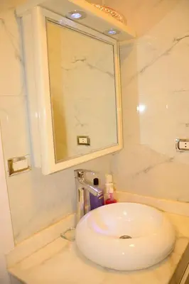a bathroom with a white sink and a mirror at GoEgypt Dreams in Hurghada