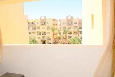 a window with a view of a building at GoEgypt Dreams in Hurghada