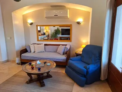 a living room with a couch and a table at Bella Sabina, Lovely one bedroom chalet with pool in Hurghada