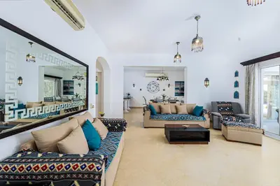 a large living room with couches and a mirror at Stunning villa with private heatable pool in Hurghada