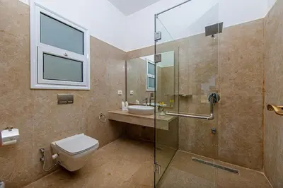 a bathroom with a shower and a toilet and a sink at Stunning villa with private heatable pool in Hurghada