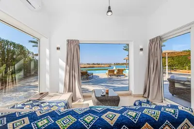a bedroom with a bed and a view of the ocean at Stunning villa with private heatable pool in Hurghada