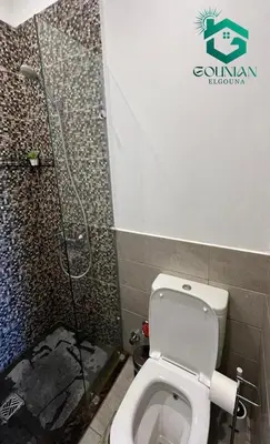 a bathroom with a toilet and a shower at Sholan, 1 Bedroom, Ground floor in Hurghada