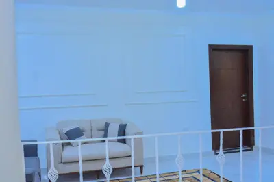 a living room with a couch and a door at Jasmin house in ‘Ezbet Abu Ḥabashi