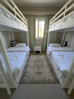 two bunk beds in a room with a window at SunShine Joubal view in Hurghada