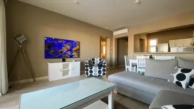 a living room with a couch and a table at SunShine Joubal view in Hurghada