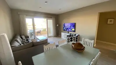 a living room with a white table and a couch at SunShine Joubal view in Hurghada