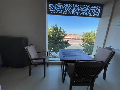 a dining room with a table and chairs and a window at SunShine Mangroovy-M10 in Hurghada