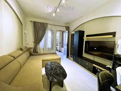 a living room with a couch and a flat screen tv at SunShine Y1-0-6 in Hurghada