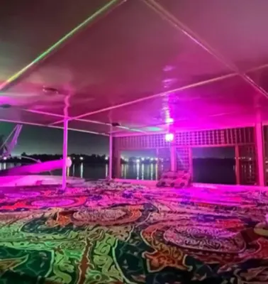a room with pink lights in a room with a carpet at Nile Bride Felucca in Aswan
