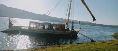 a boat is docked in the water on a lake at Nile Bride Felucca in Aswan