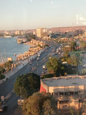 a view of a city with a river and buildings at Monty Homestay in Aswan