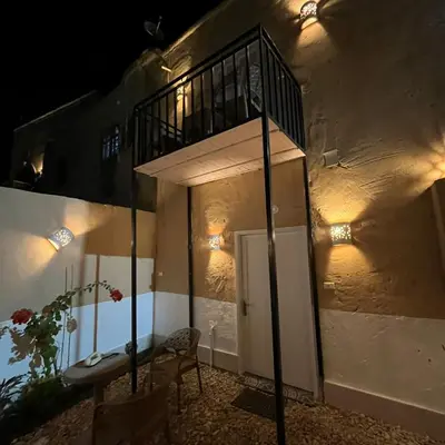 a building with a staircase on the side of it at Habu House Luxor in Luxor