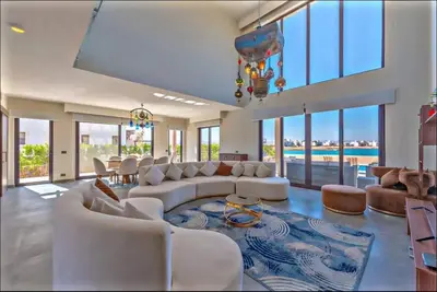 a large living room with white furniture and a pool at Luxury villa in gouna in Hurghada