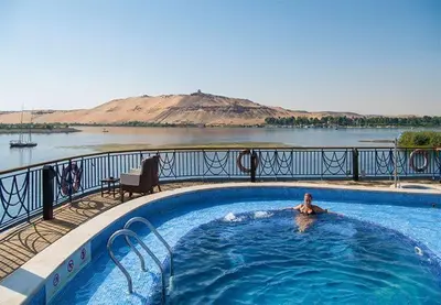 a person swimming in a swimming pool on a resort at 4 Days Nile Cruise from Luxor to Aswan in Luxor