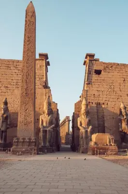 a building with statues on it with a obelisk at 4 Days Nile Cruise from Luxor to Aswan in Luxor