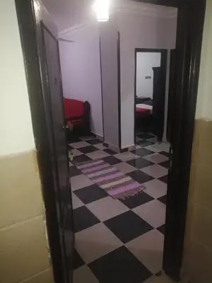 a hallway with a black and white checkered floor at Al Dahar apartments Hurghada in Hurghada