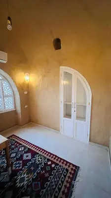 a room with a door and a rug on the floor at Nubian House in Al Aqālitah