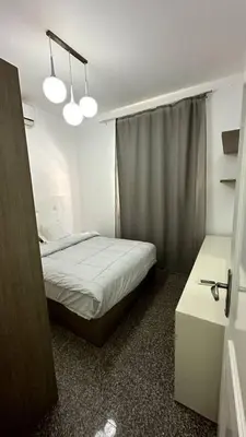 a small bedroom with a bed and a window at A 2 BR with pool view Hurghada in Hurghada