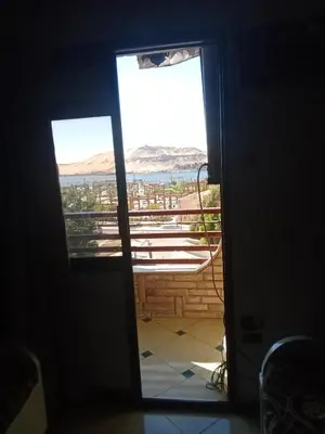 a door leading to a balcony with a view of the ocean at شقه ب موقع متميز عل النيل in Maḩaţţat ash Shallāl