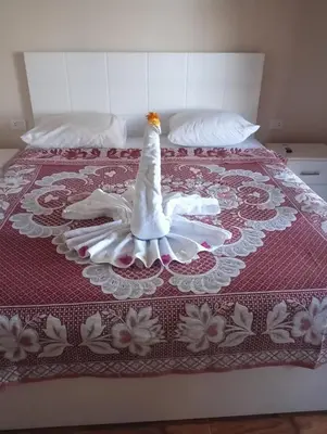 a bed with a wedding dress on top of it at Nile House Anis & Do in Luxor