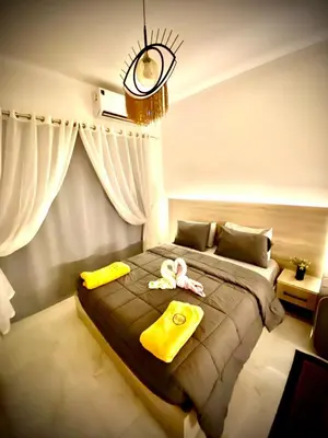 a bedroom with a bed with yellow items on it at Juliana Beach in Hurghada