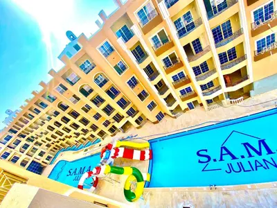 a large hotel building with a swimming pool at Juliana Beach in Hurghada