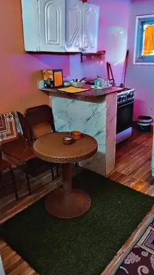 a kitchen with a table and a counter top at وسط البلد البلدوزر بجوار مستشفي النيل التخصصي in Aswan