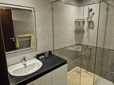 a bathroom with a sink and a glass shower at قرية الهمبرا السياحية بالغردقة in Hurghada