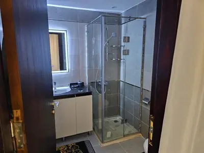 a bathroom with a shower and a sink at قرية الهمبرا السياحية بالغردقة in Hurghada
