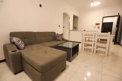 a living room with a couch and a table at Villa Abo Tarek in Al Aqālitah