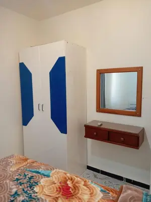 a bedroom with a mirror and a bed and a dresser at Al-Kiam Villa A F in Hurghada