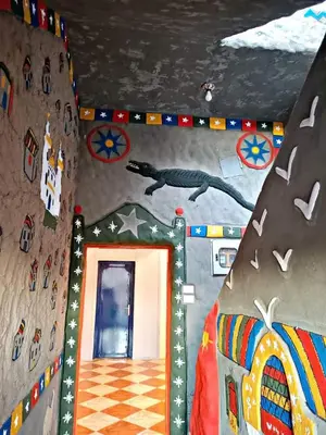 a room with a wall with a dinosaur painted on it at Noury kato in Jazīrat ‘Awwāḑ