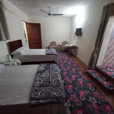 a hotel room with two beds and a rug at Remal City in Luxor