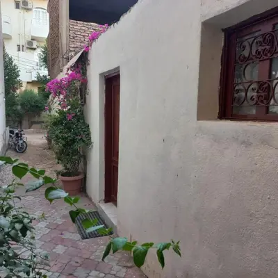 a white building with a door and a window at Remal City in Luxor
