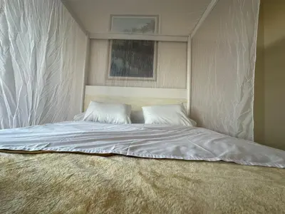a bed with two pillows on top of it at TibaHouse in Luxor